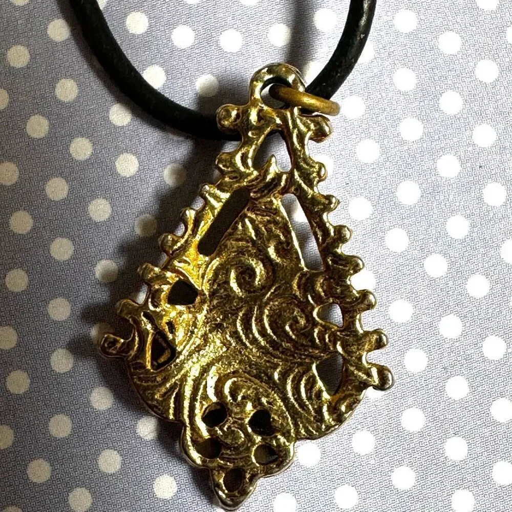Green and gold tone pendant necklace on black cord